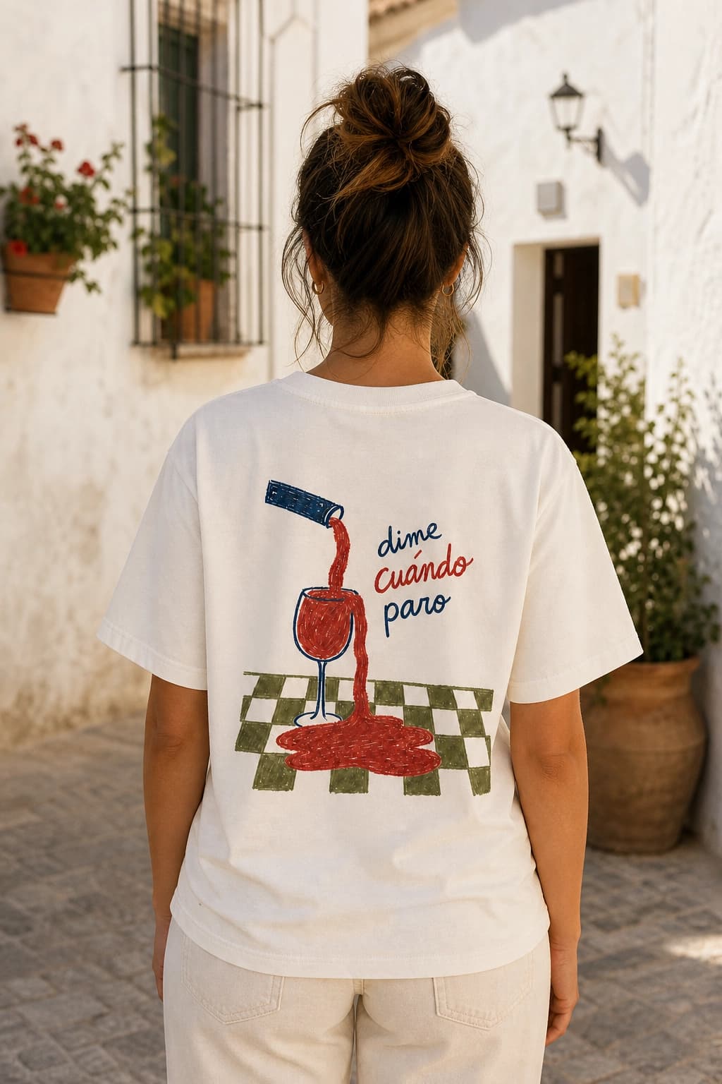 Chica de espaldas con la camiseta Dime Cuándo en una calle andaluza
